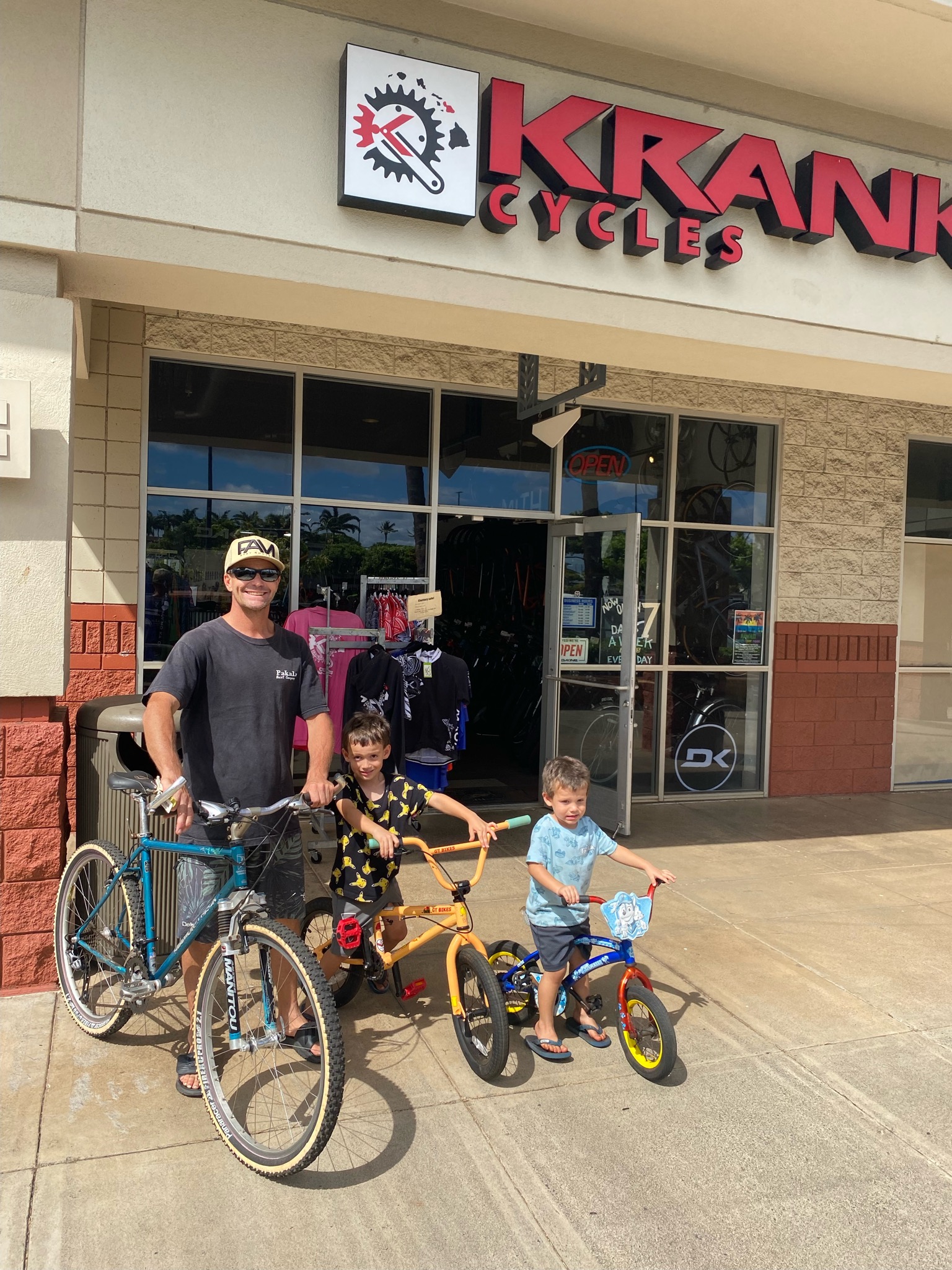 A West Maui Cycles employee and kids with bikes donated by  Krank Cycles.