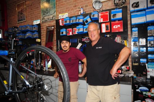 Epic Cycles owner Allan Hightower, right, with mechanic Alonso Gutierrez.