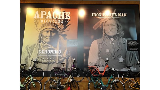 Giant wall-mounted Native American faces loomed over Apache's bike display.