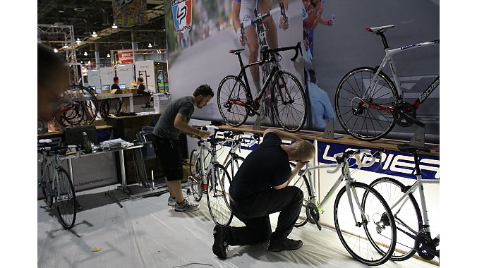 SBS employees set up and clean bikes for Wednesday's show opening. Photo: Steve Frothingham