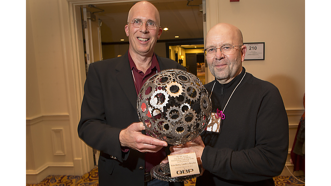 Tom Henry, of Boston's Landry's Bicycles, accepts the 2013 Clay Mankin Award for Outstanding Leadership in the Cycling Industry. The award was presented by Gary Sjoquist, QBP advocacy director.
