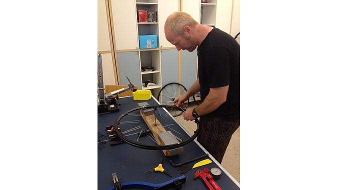 Product developer Tim Young demonstrates wheel assembly. All Crankbrothers wheels are 100 percent hand-built in Taiwan.