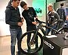 Dominik Geyer (middle), Specialized’s Turbo product manager, talks battery life and other details with customers in the new pop-up store. 