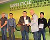 Taiwan Bicycle Exporters Association chairman Tony Lo hands out Design and Innovation awards following the pre-show press conference. In its second year, the D&I Awards recognized 44 products out of 184 submissions. 