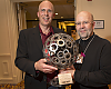 Tom Henry, of Boston's Landry's Bicycles, accepts the 2013 Clay Mankin Award for Outstanding Leadership in the Cycling Industry. The award was presented by Gary Sjoquist, QBP advocacy director.